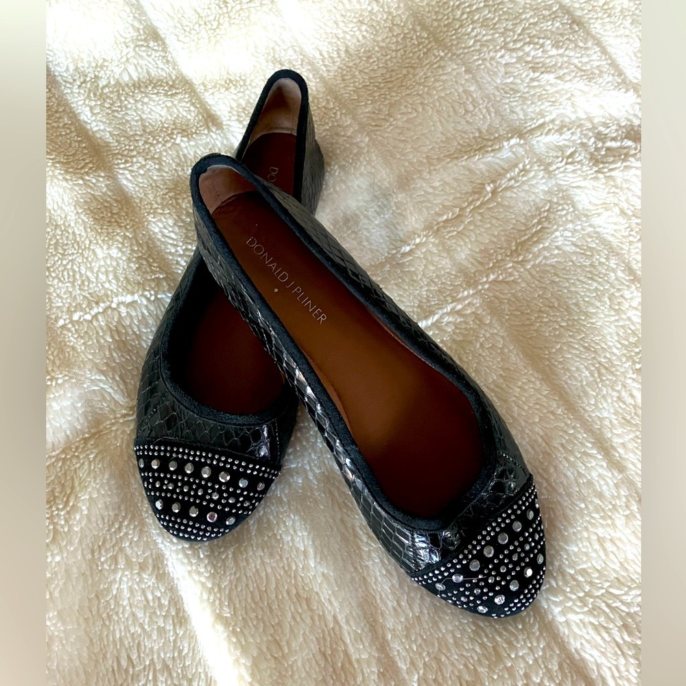 DJ Pliner black snakeskin flats with metal accents. Size 6.5. Leather soles.